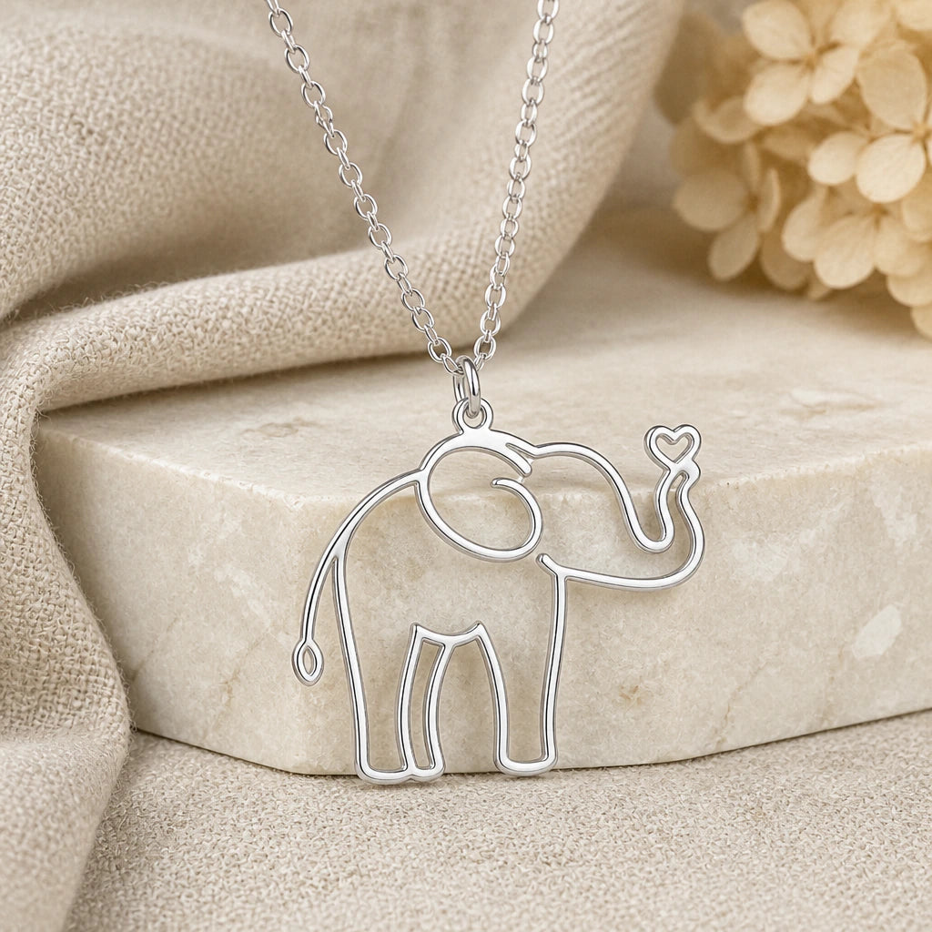 925 sterling silver elephant outline pendant necklace on softly folded cream linen