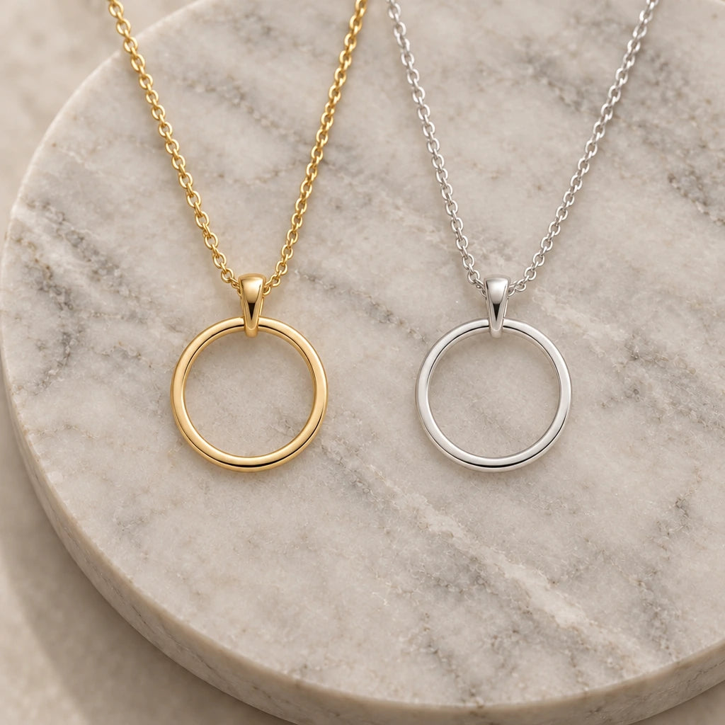 Open Circle Eternity pendant necklace in silver and gold finishes side by side
