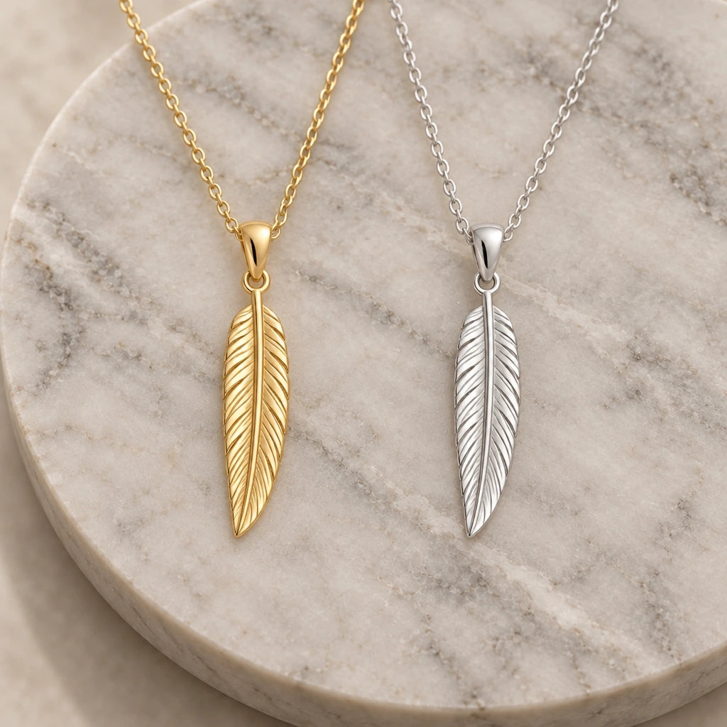 Engraved Feather pendant necklace in silver and gold finishes side by side