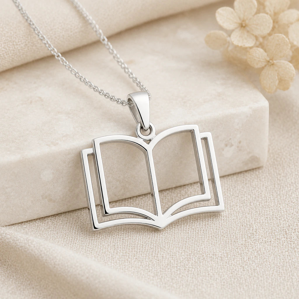 925 sterling silver open book pendant necklace on softly folded cream linen