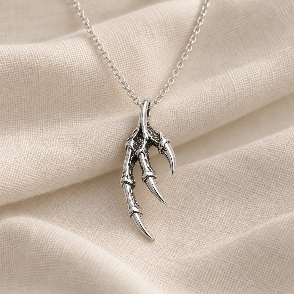 925 sterling silver dragon claw pendant necklace on cream fabric