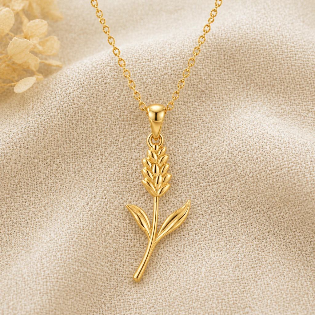 Statice Flower pendant necklace in a warm gold finish on cream fabric