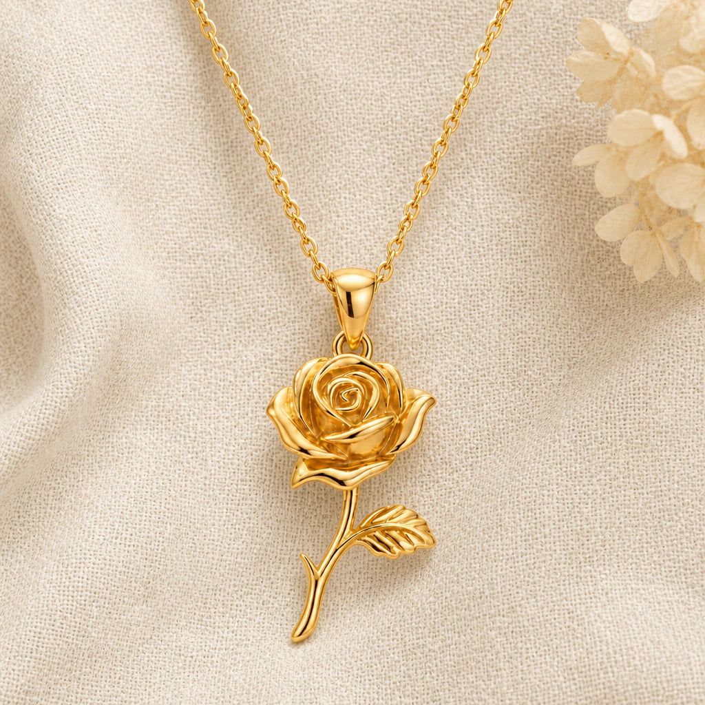 Rose Flower pendant necklace in a warm gold finish on cream fabric