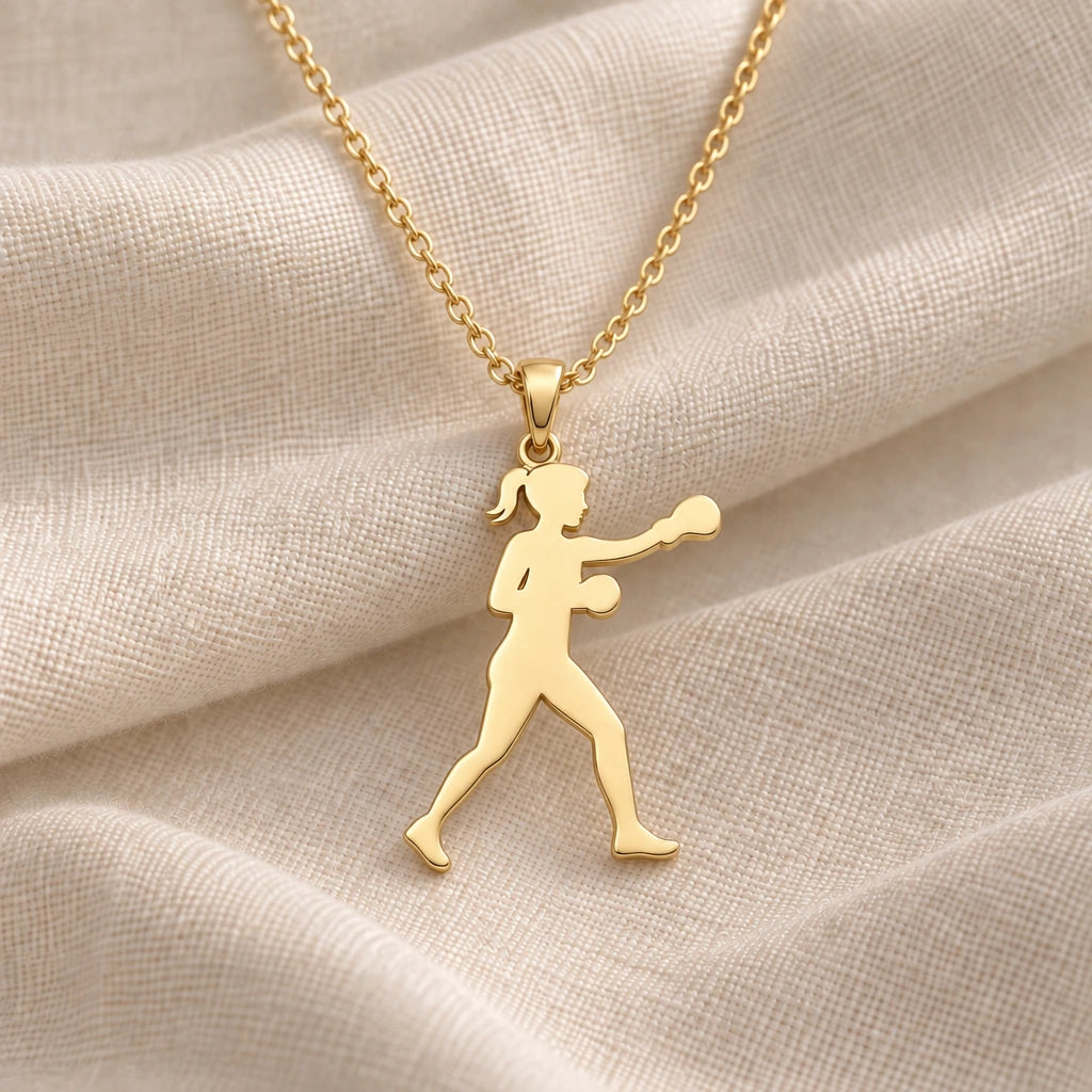 Female Boxer Punch pendant necklace in an 18k gold plated finish