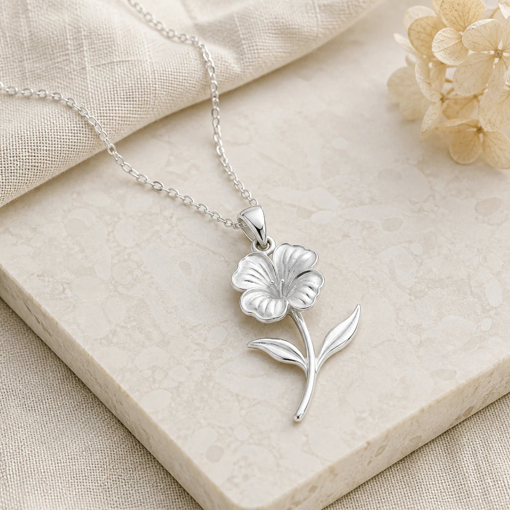Close-up of silver nasturtium flower pendant showing the sculpted detail