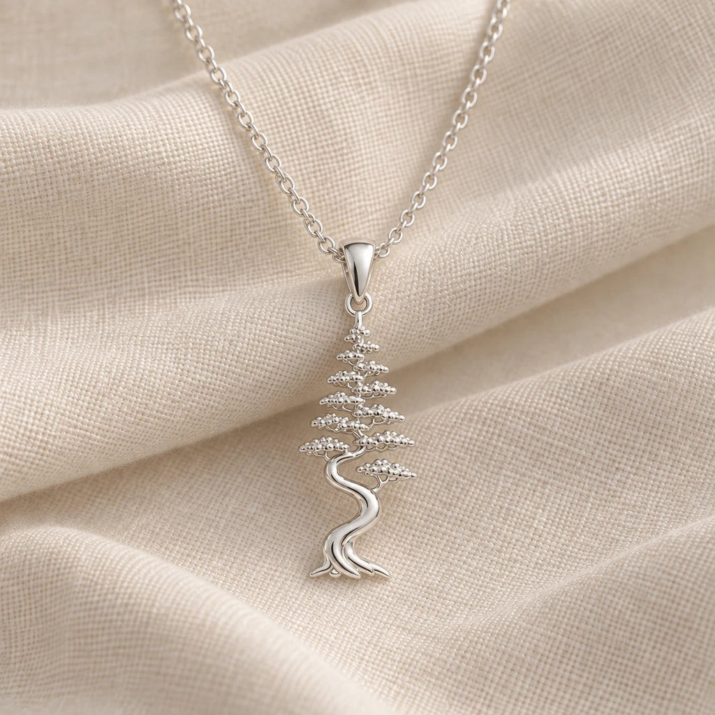 925 sterling silver cypress aura bonsai pendant necklace on cream fabric