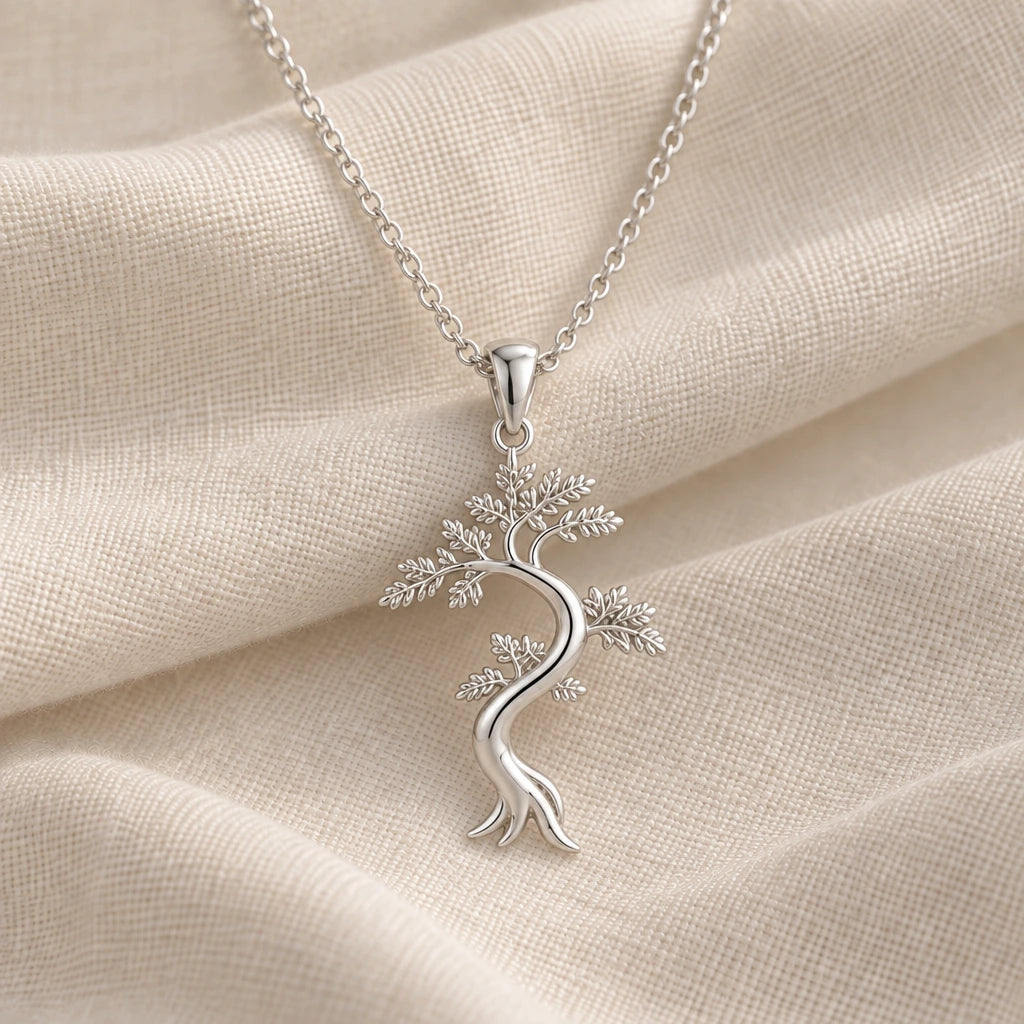 925 sterling silver juniper flame feathered tree pendant necklace on cream fabric