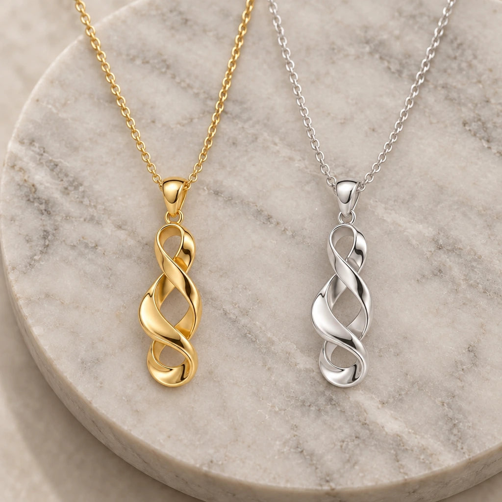 Sculptural Twisted Ribbon pendant necklace in silver and gold finishes side by side