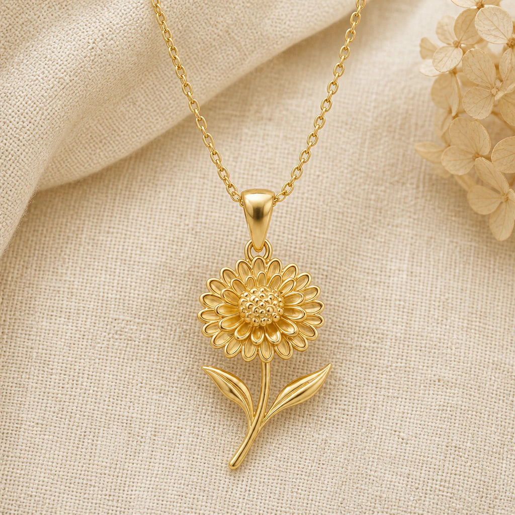 Chrysanthemum Bloom Flower pendant necklace in a warm gold finish on cream fabric