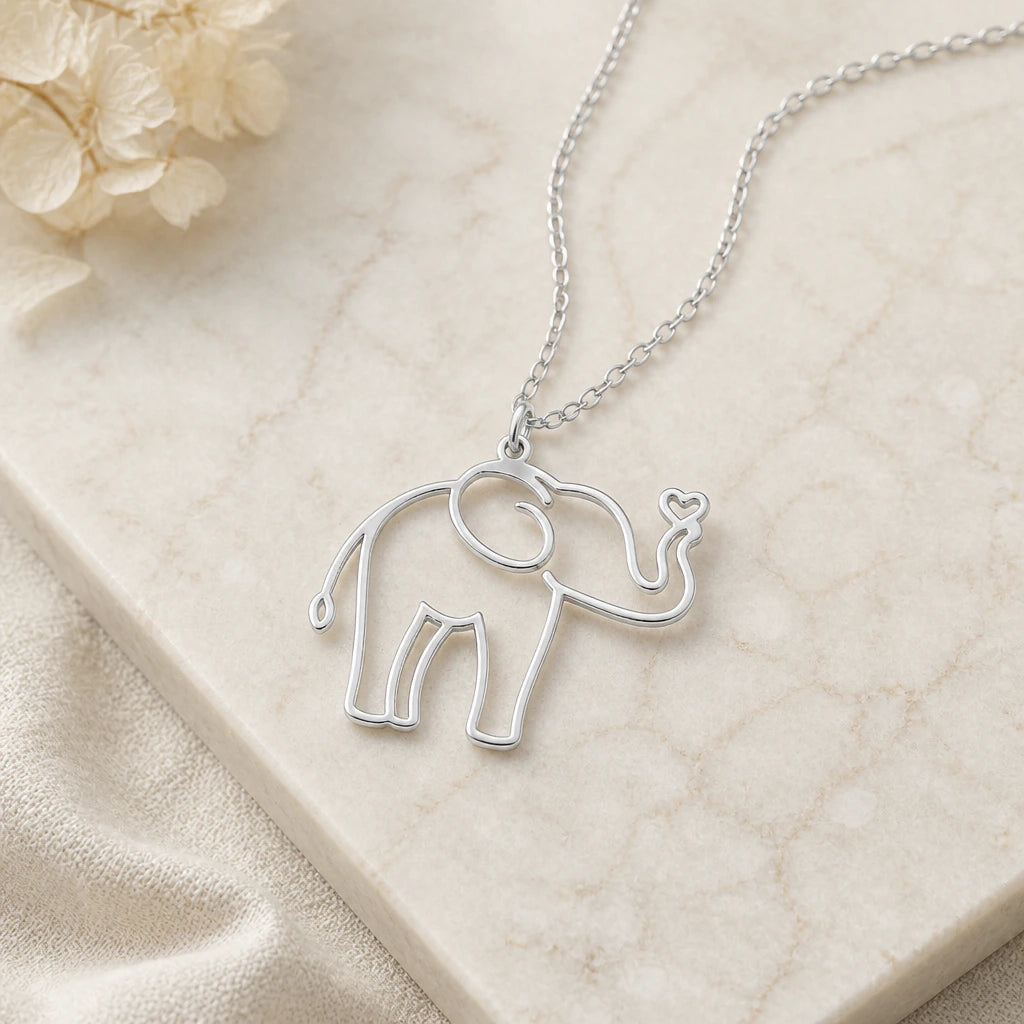 Close-up of silver elephant outline pendant showing the sculpted detail