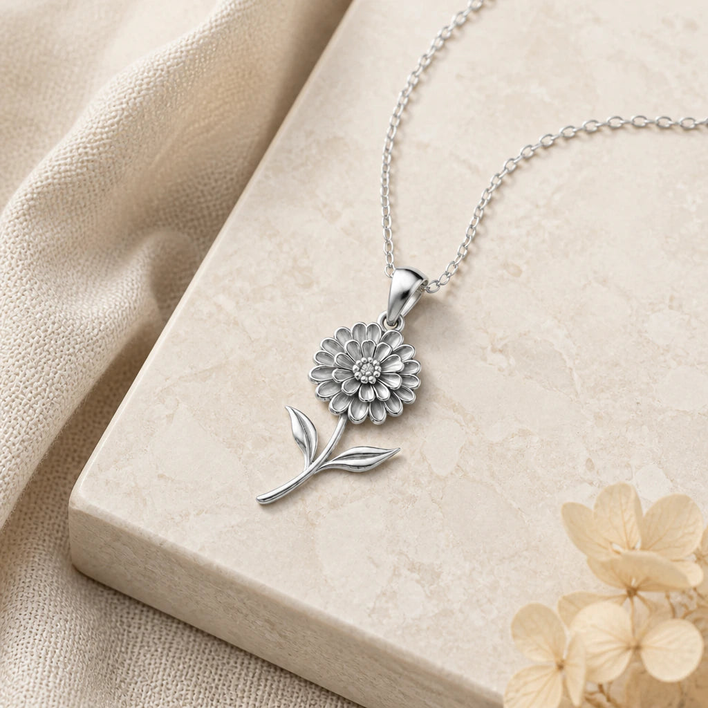 Close-up of silver zinnia flower pendant showing the sculpted detail