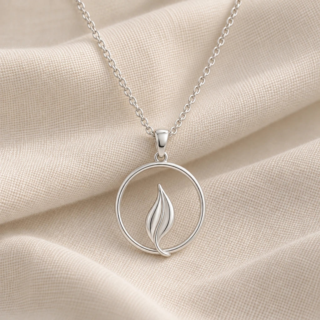 925 sterling silver halo leaf pendant necklace on cream fabric