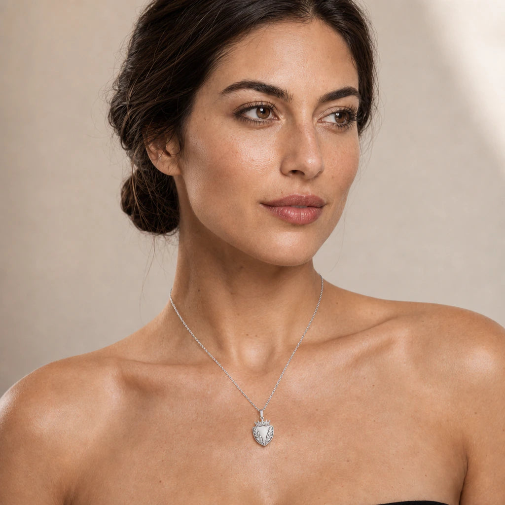Oak Leaf Shield Crown pendant necklace worn on a model, front close-up