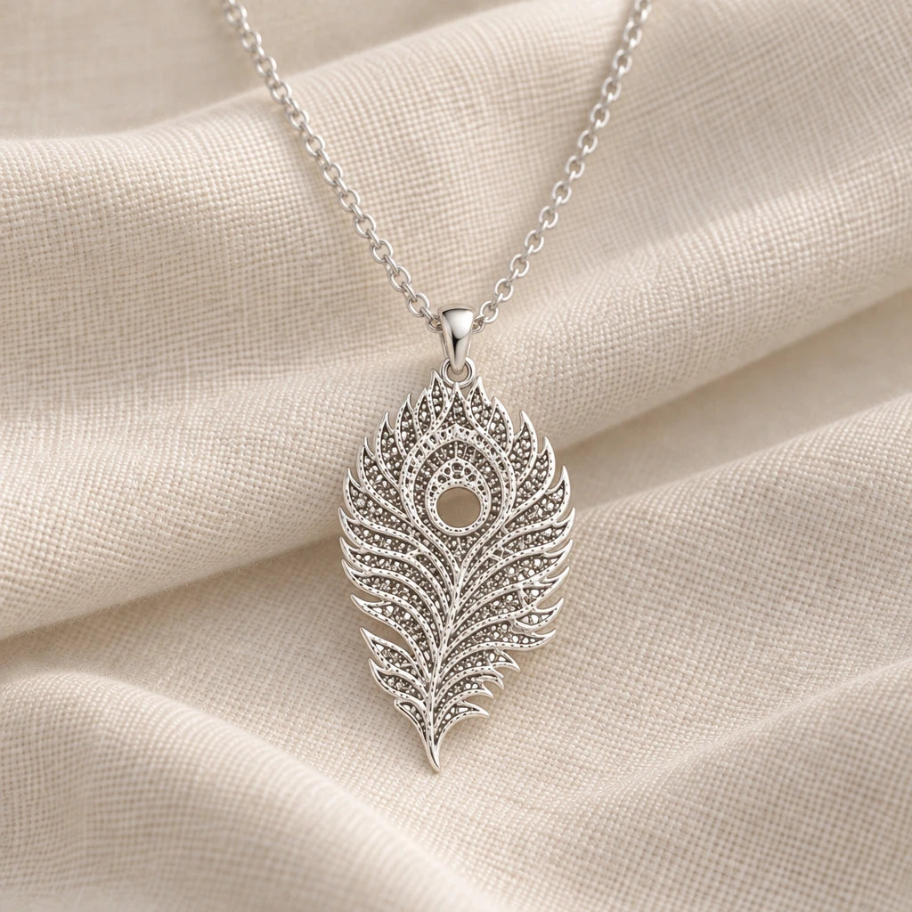 925 sterling silver lunar peacock feather pendant necklace on cream fabric
