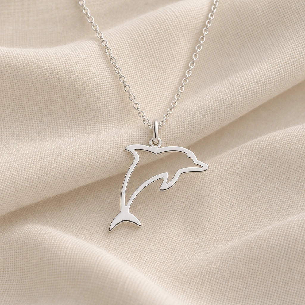 925 sterling silver leaping dolphin outline pendant necklace on cream fabric