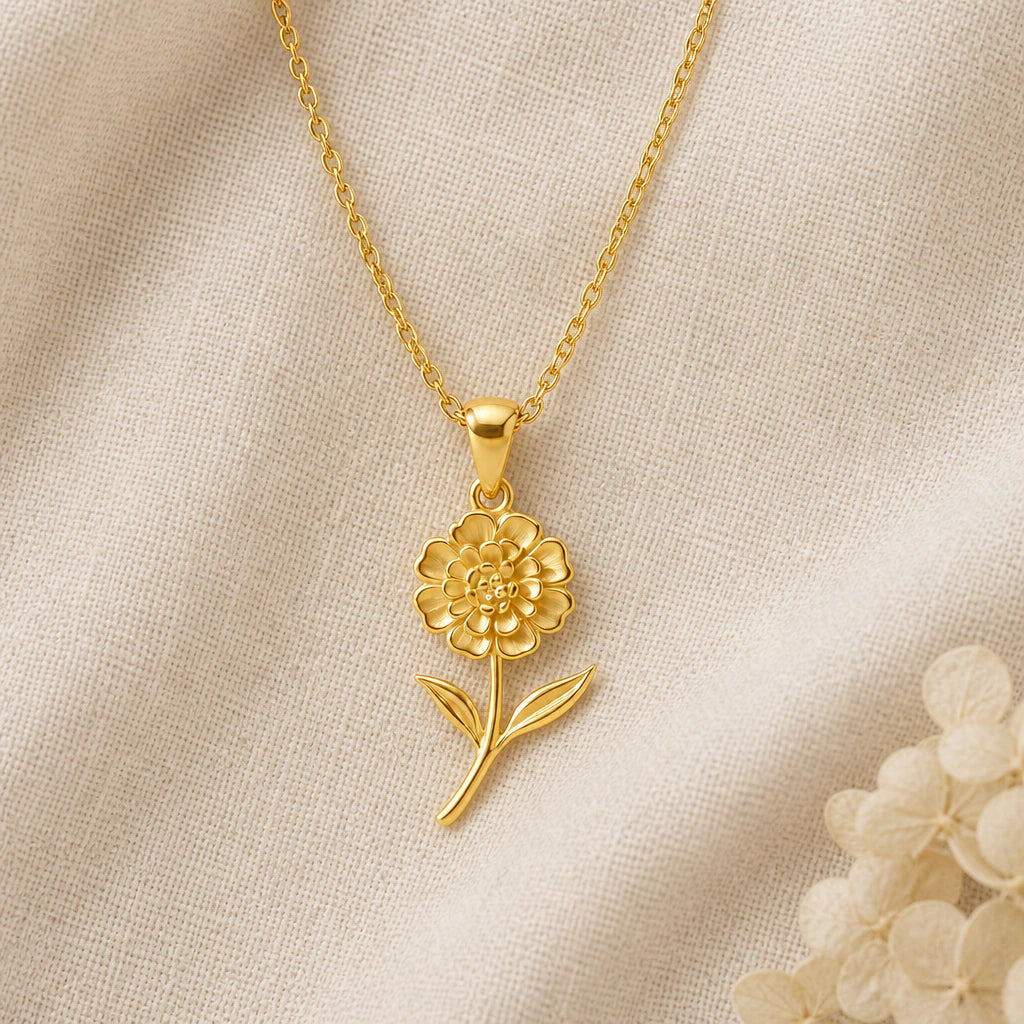 Lantana Flower pendant necklace in a warm gold finish on cream fabric