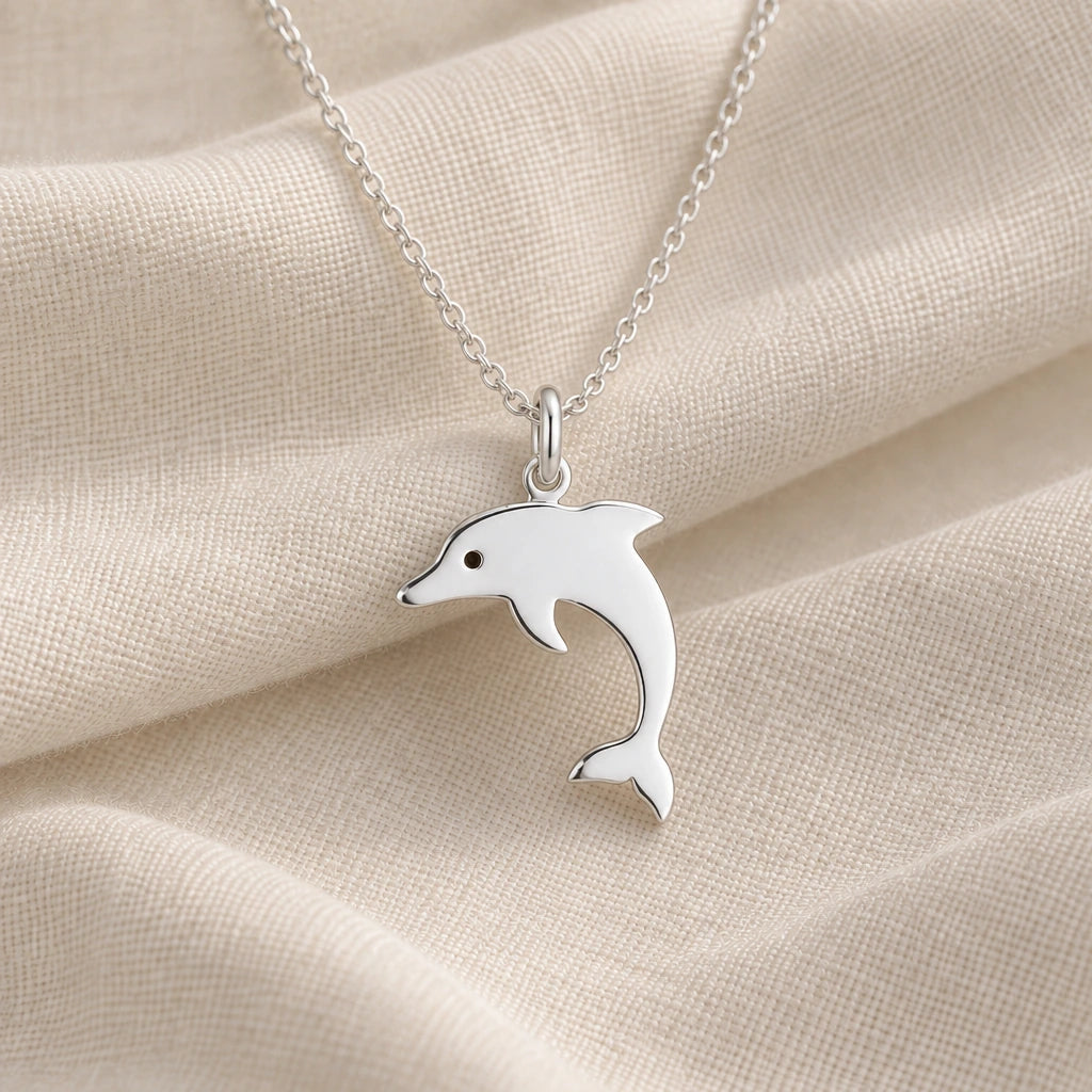 925 sterling silver dolphin silhouette pendant necklace on cream fabric
