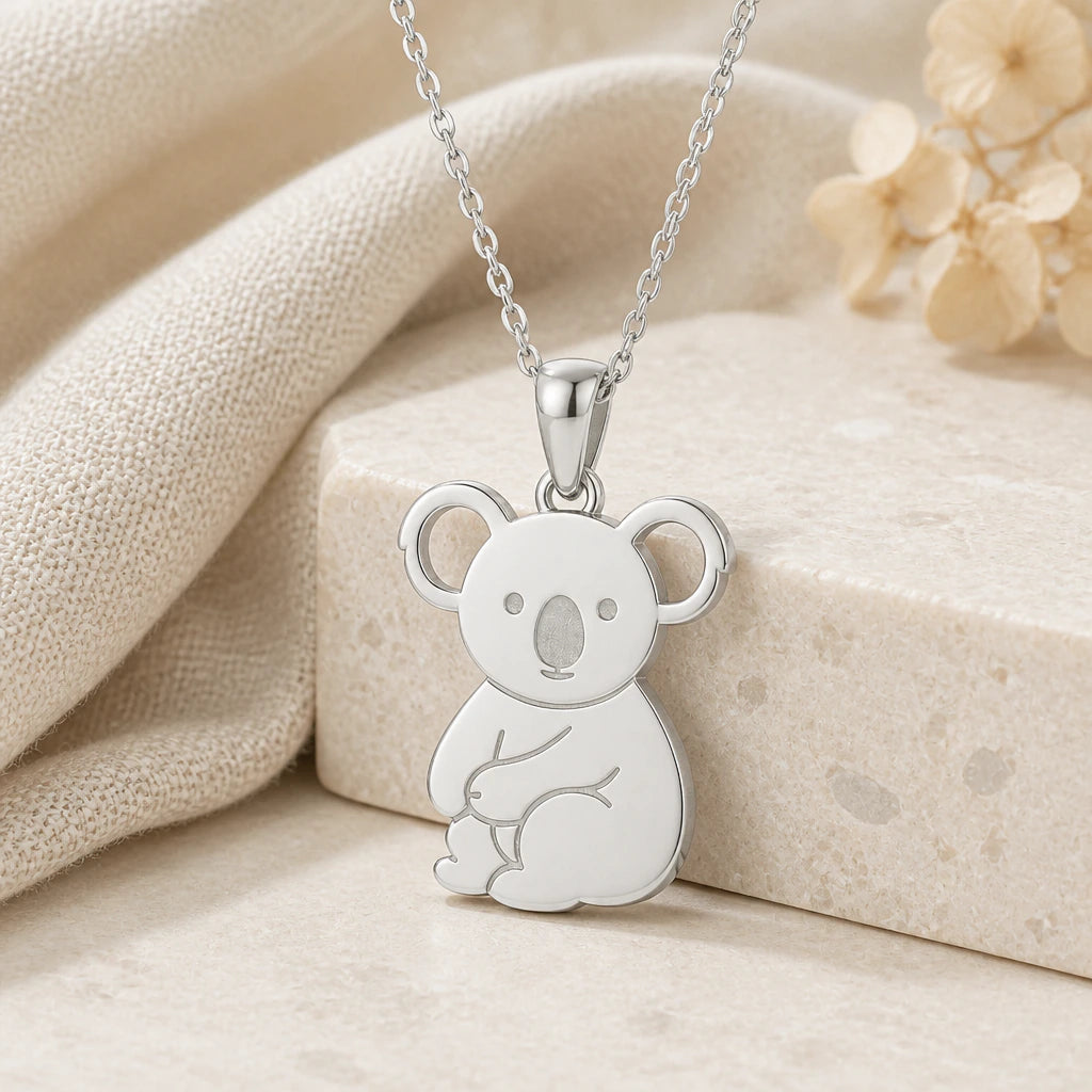925 sterling silver koala pendant necklace on softly folded cream linen