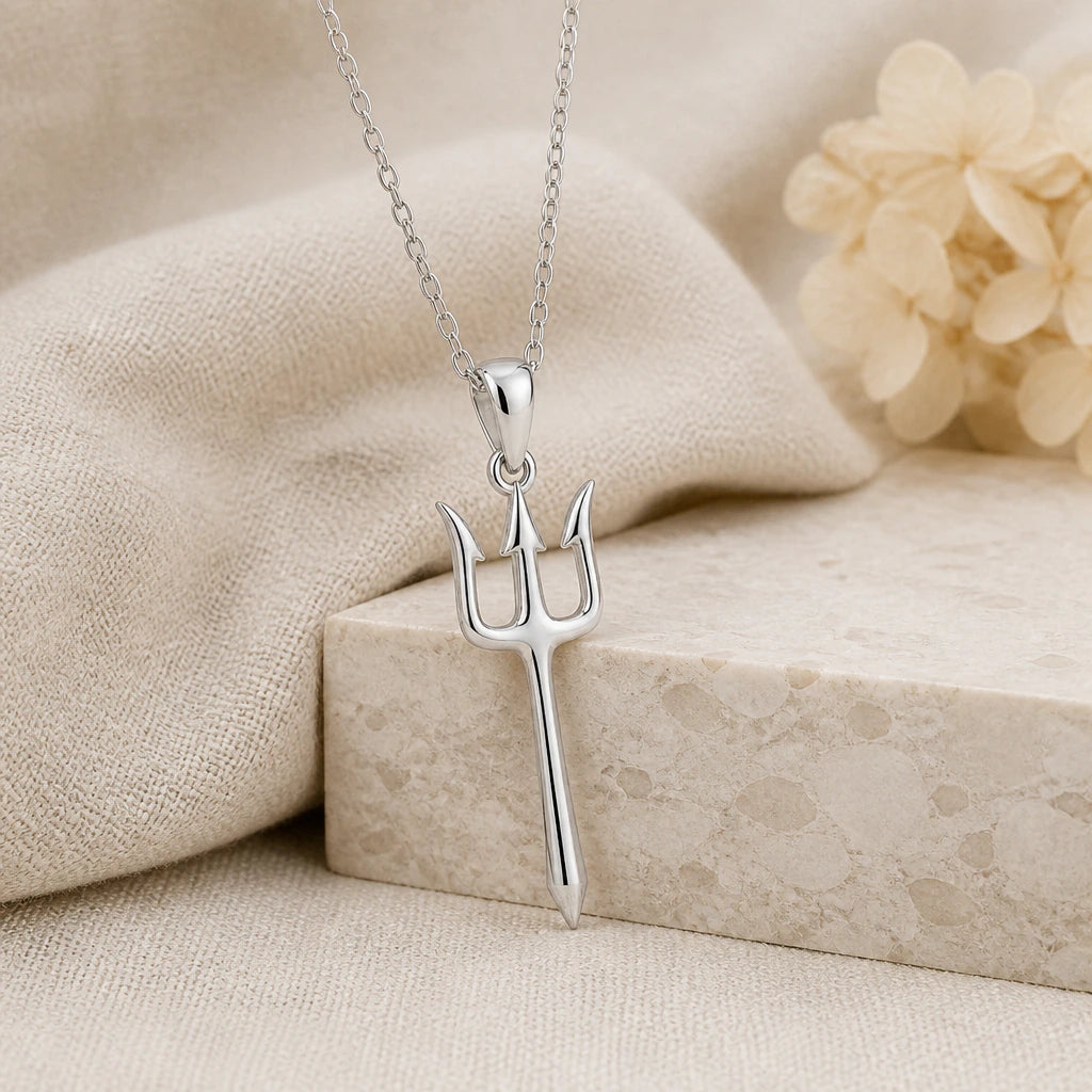925 sterling silver trident pendant necklace on softly folded cream linen
