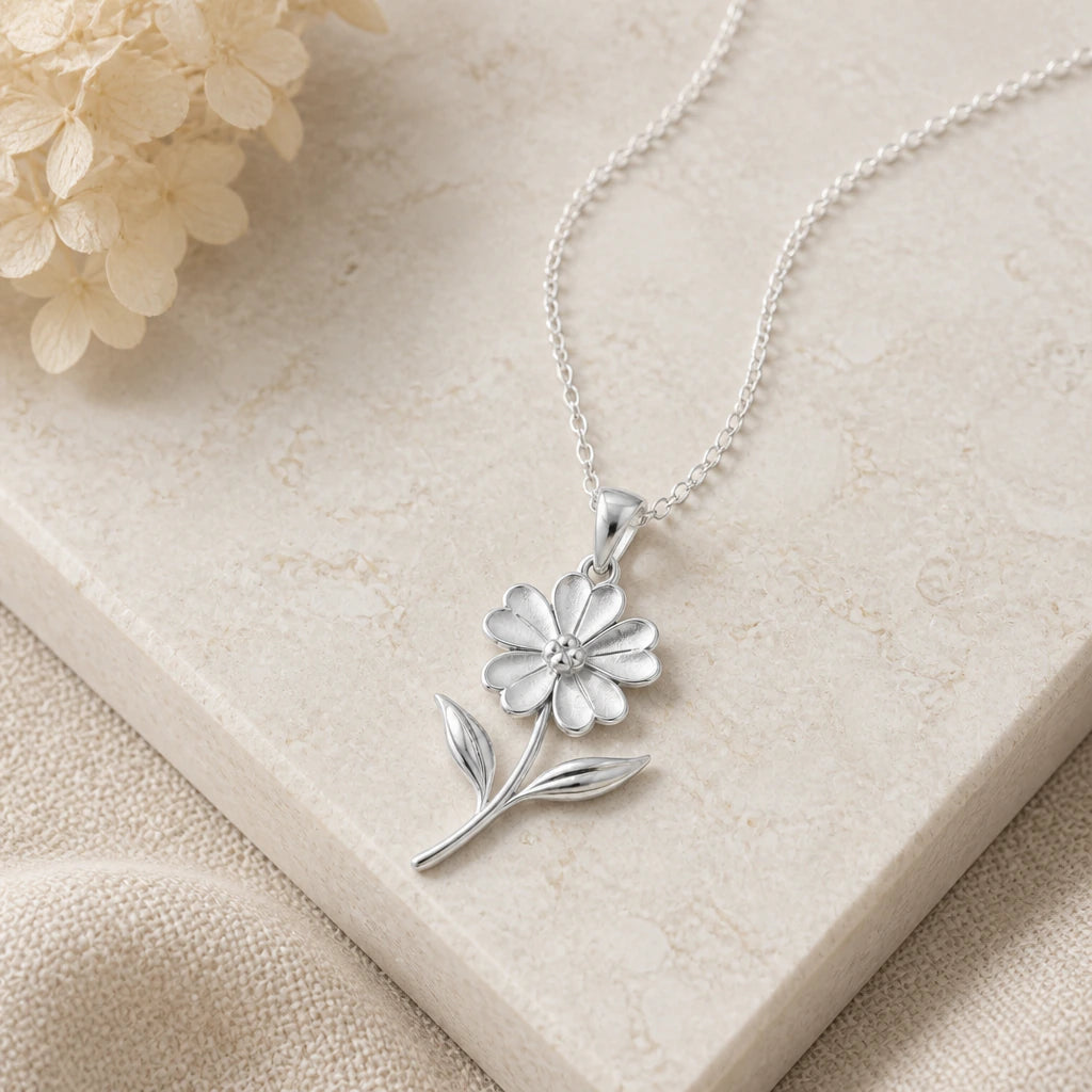 Close-up of silver verbena flower pendant showing the sculpted detail