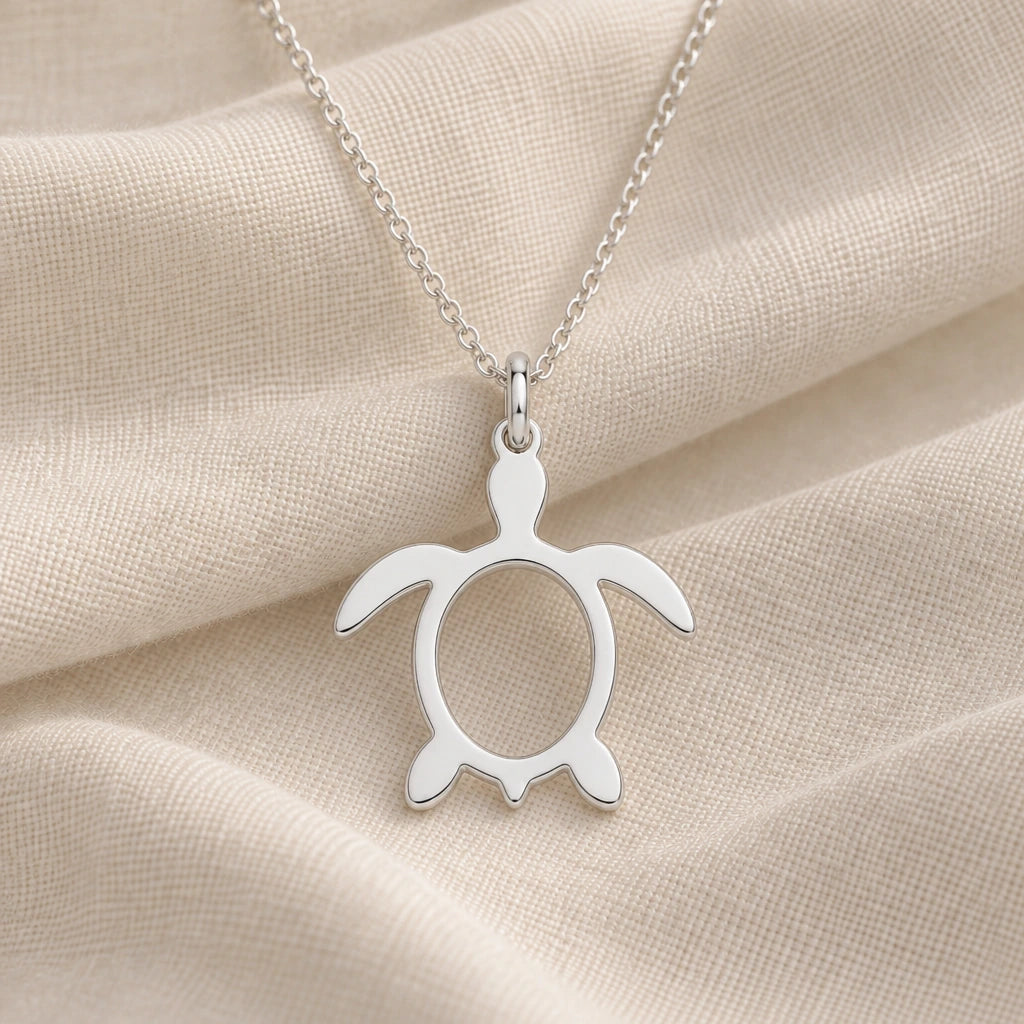 925 sterling silver sea turtle outline pendant necklace on cream fabric