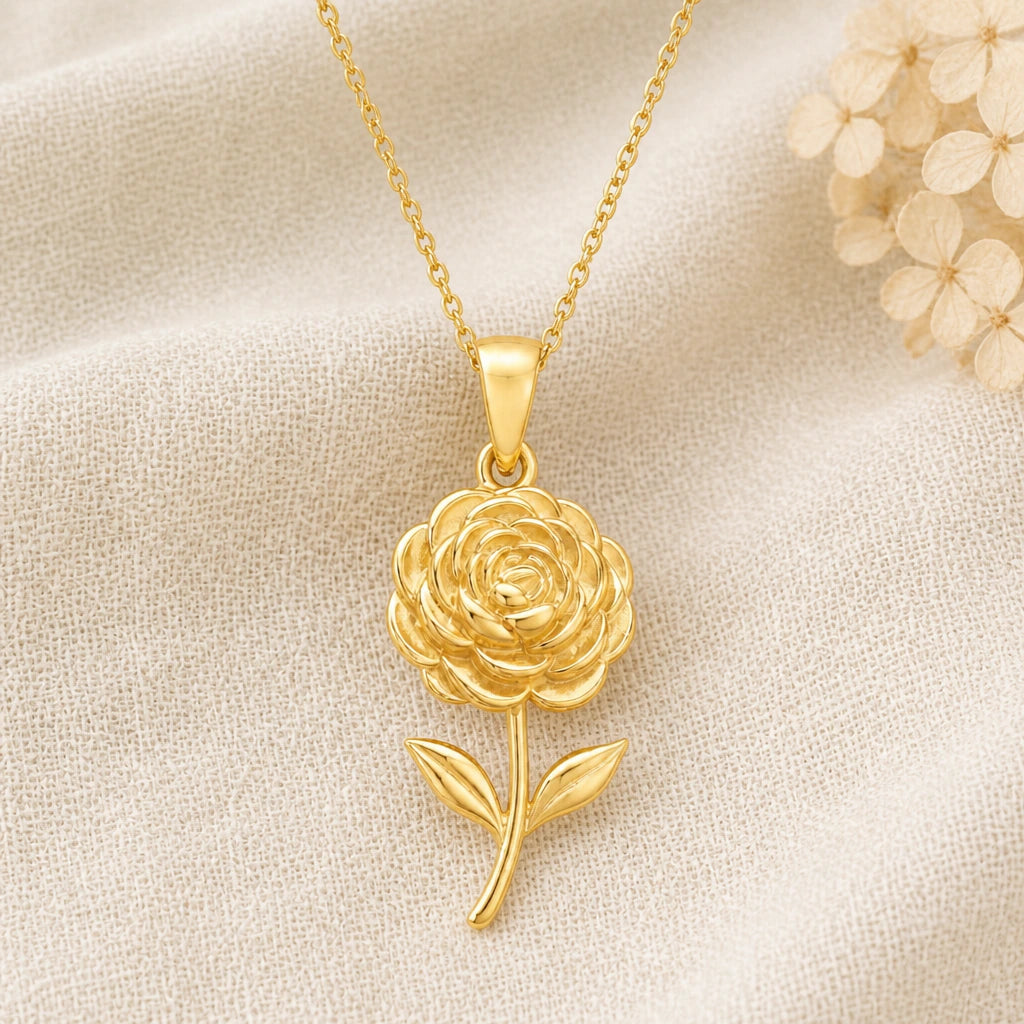 Ranunculus Flower pendant necklace in a warm gold finish on cream fabric