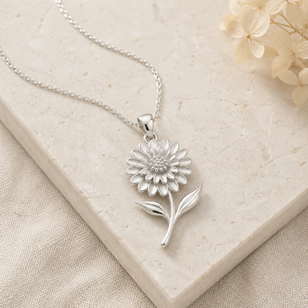 Close-up of silver dahlia flower pendant showing the sculpted detail