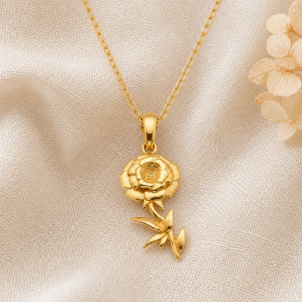 Marigold Flower pendant necklace in a warm gold finish on cream fabric