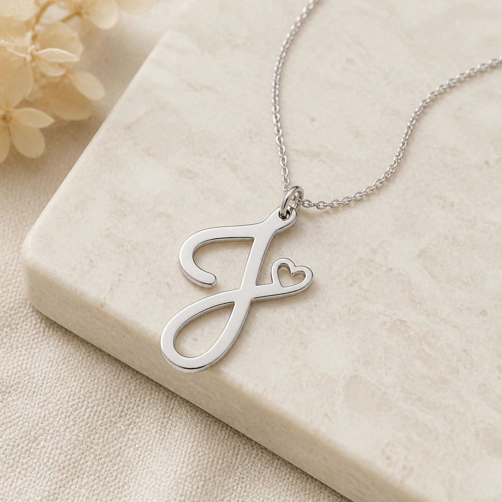 Close-up of silver j initial heart pendant showing the sculpted detail