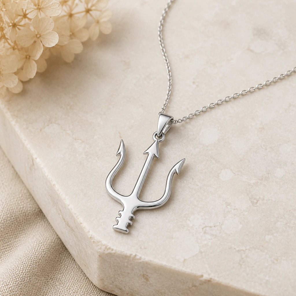 Close-up of silver neptune trident pendant showing the sculpted detail