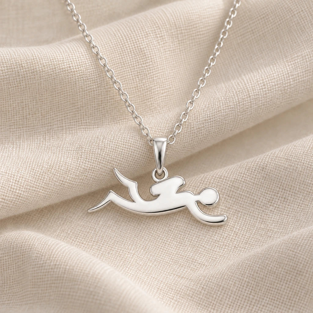 925 sterling silver swimmer glide pendant necklace on cream fabric