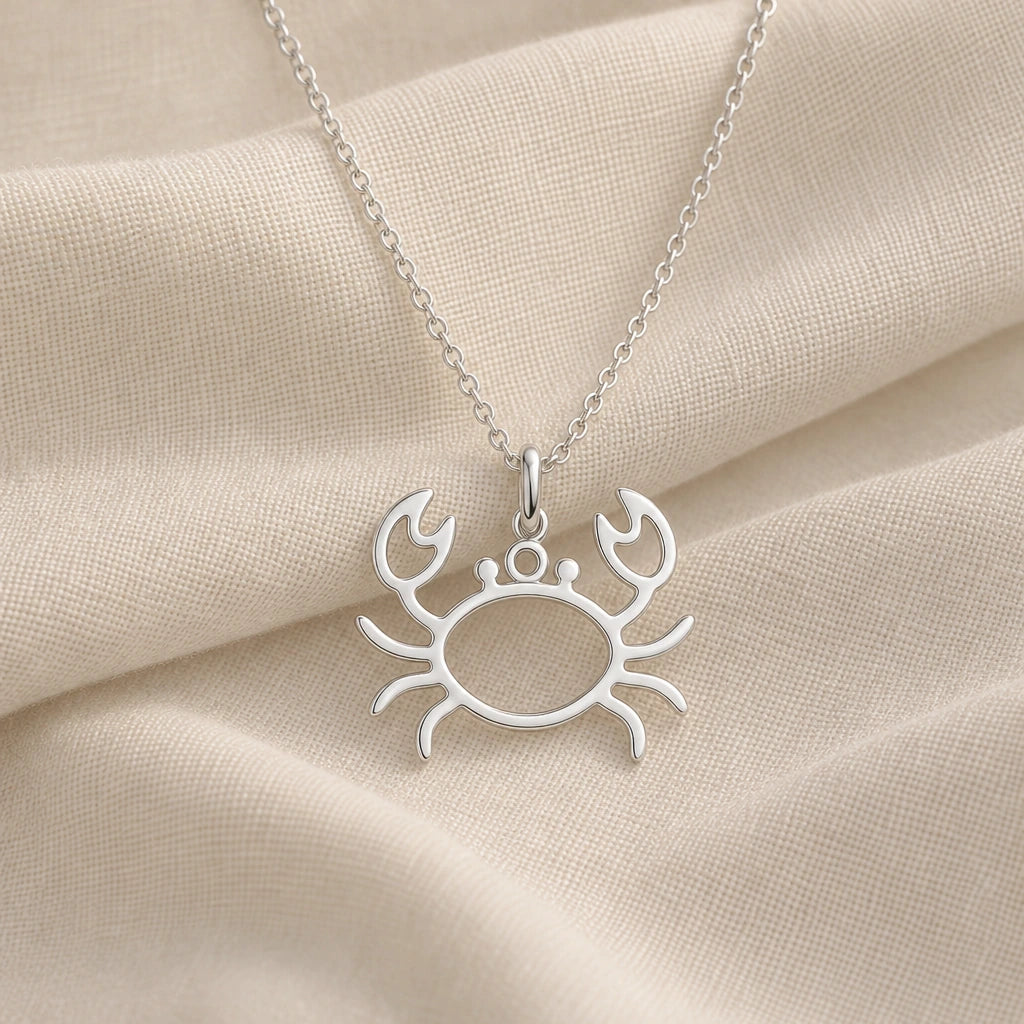925 sterling silver crab outline pendant necklace on cream fabric