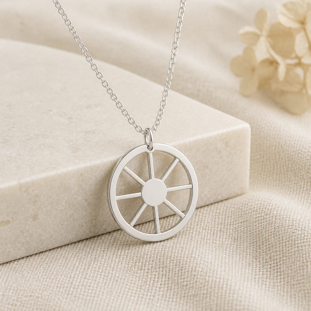 925 sterling silver sun wheel symbol pendant necklace on softly folded cream linen