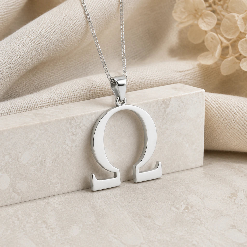 925 sterling silver omega symbol pendant necklace on softly folded cream linen