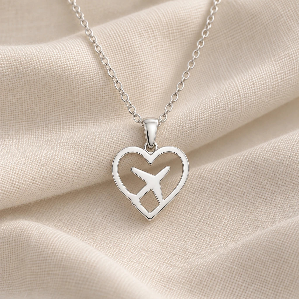 925 sterling silver heart aeroplane pendant necklace on cream fabric