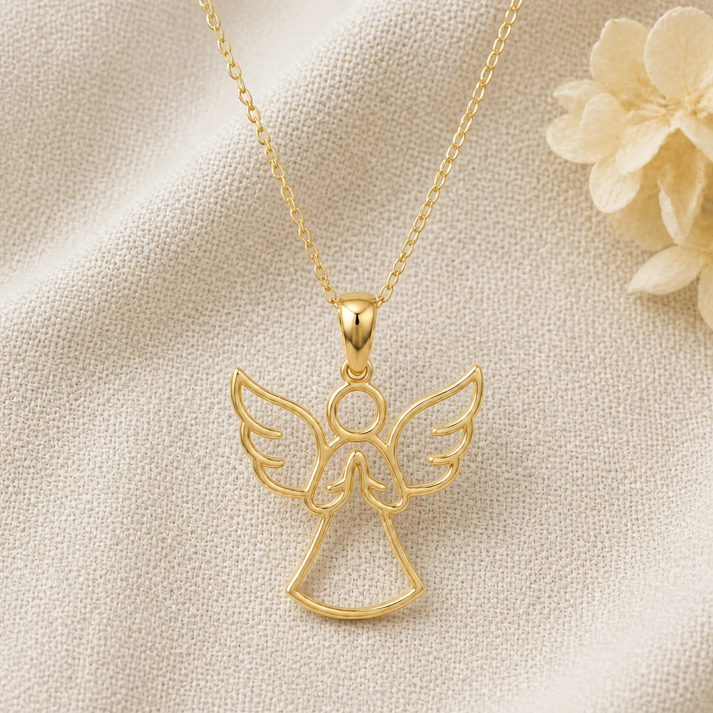 Guardian Angel pendant necklace in a warm gold finish on cream fabric