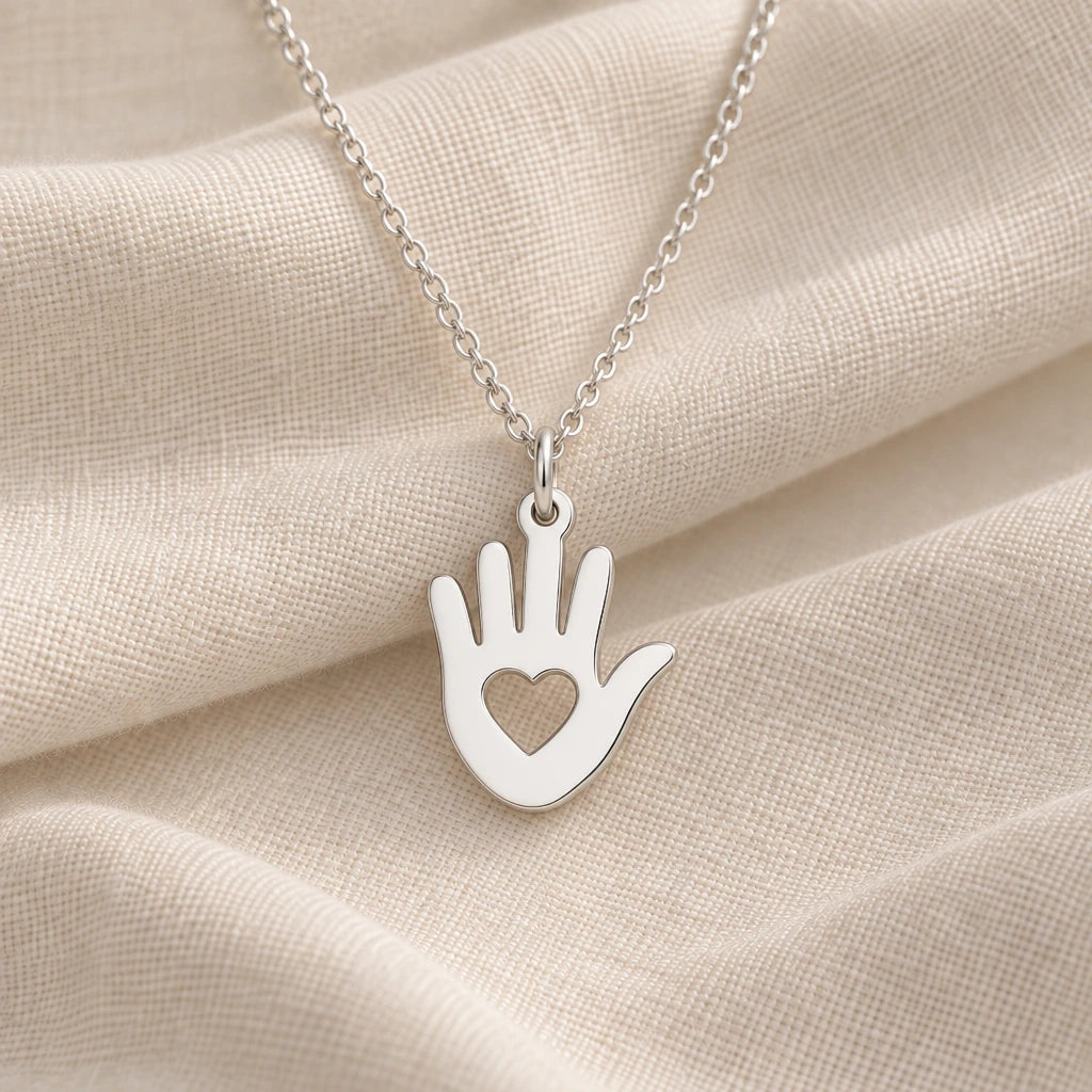 925 sterling silver helping hand heart pendant necklace on cream fabric