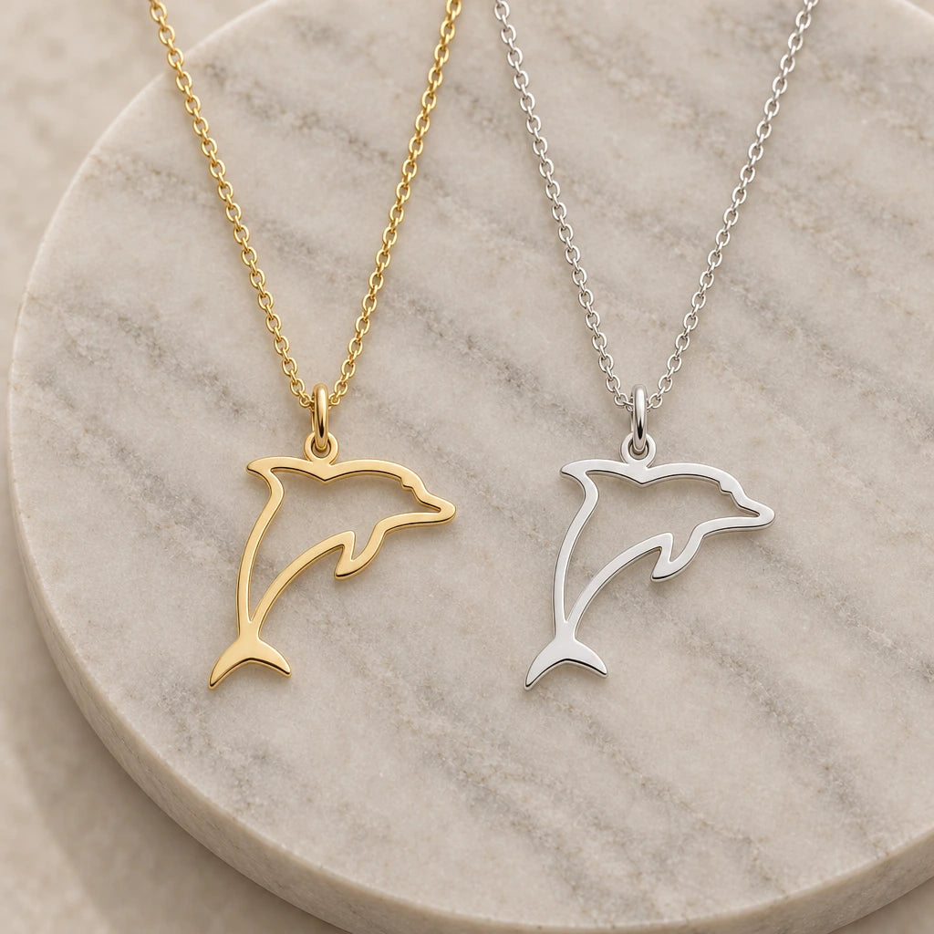 Leaping Dolphin Outline pendant necklace in silver and gold finishes side by side
