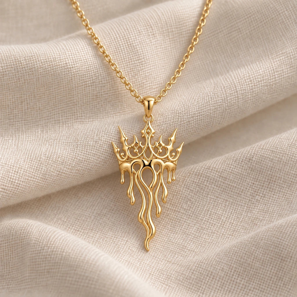 Crown Drift Melting Crown pendant necklace in an 18k gold plated finish