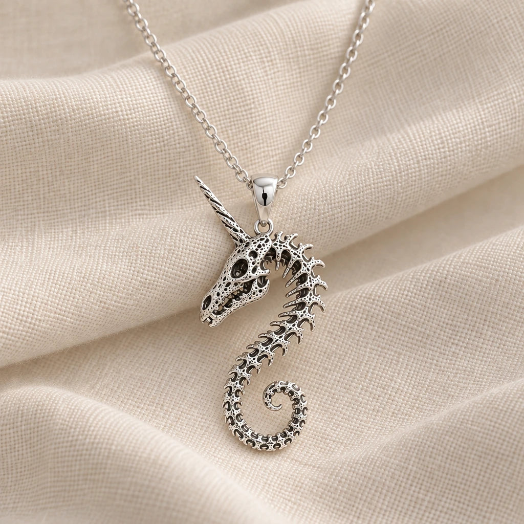 925 sterling silver fossil unicorn spine pendant necklace on cream fabric