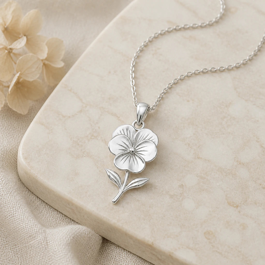 Close-up of silver pansy flower pendant showing the sculpted detail