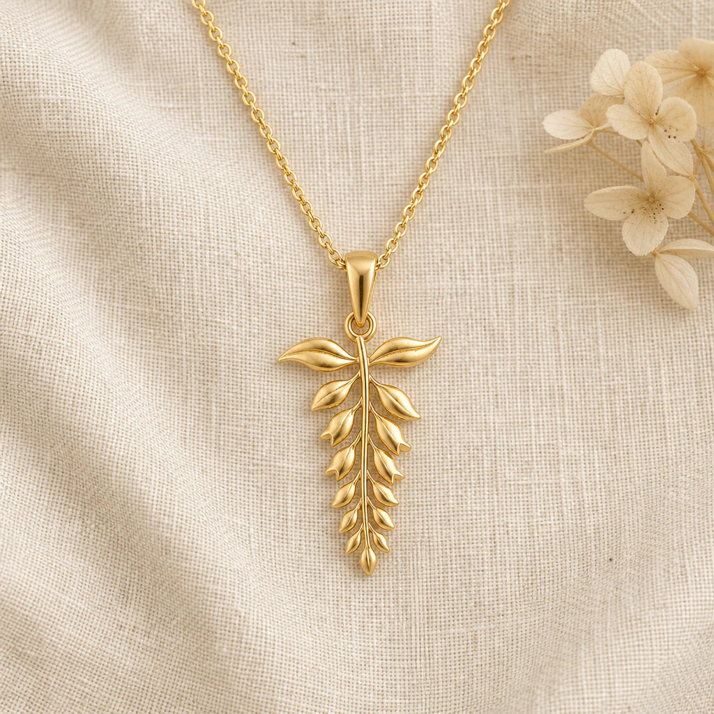 Wisteria Flower pendant necklace in a warm gold finish on cream fabric
