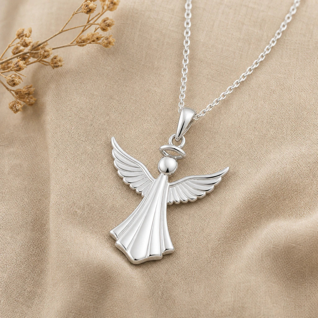 Close-up of silver angel pendant with halo and feathered wings