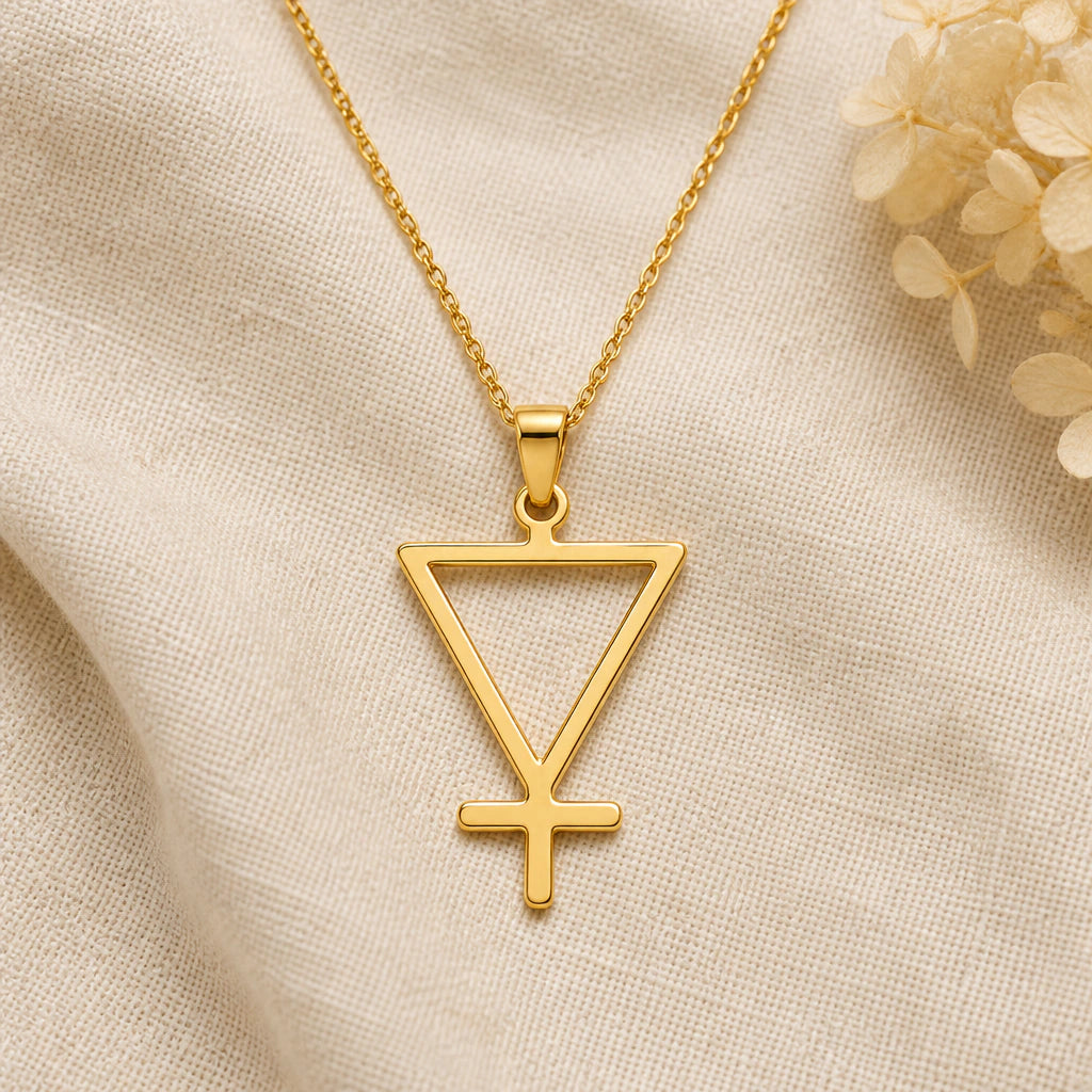Earth Element pendant necklace in a warm gold finish on cream fabric