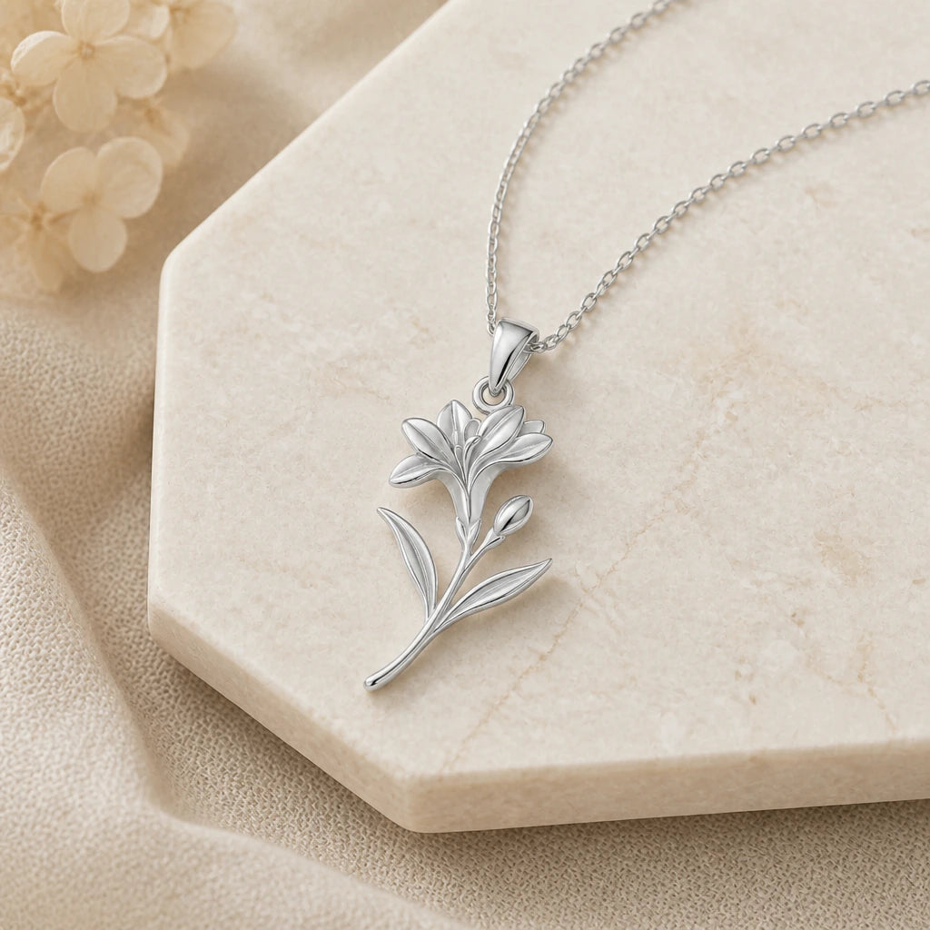 Close-up of silver freesia flower pendant showing the sculpted detail