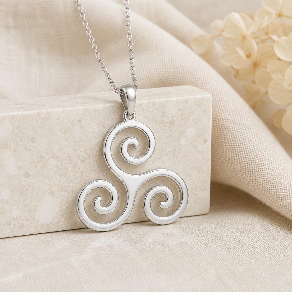 925 sterling silver triskelion pendant necklace on softly folded cream linen
