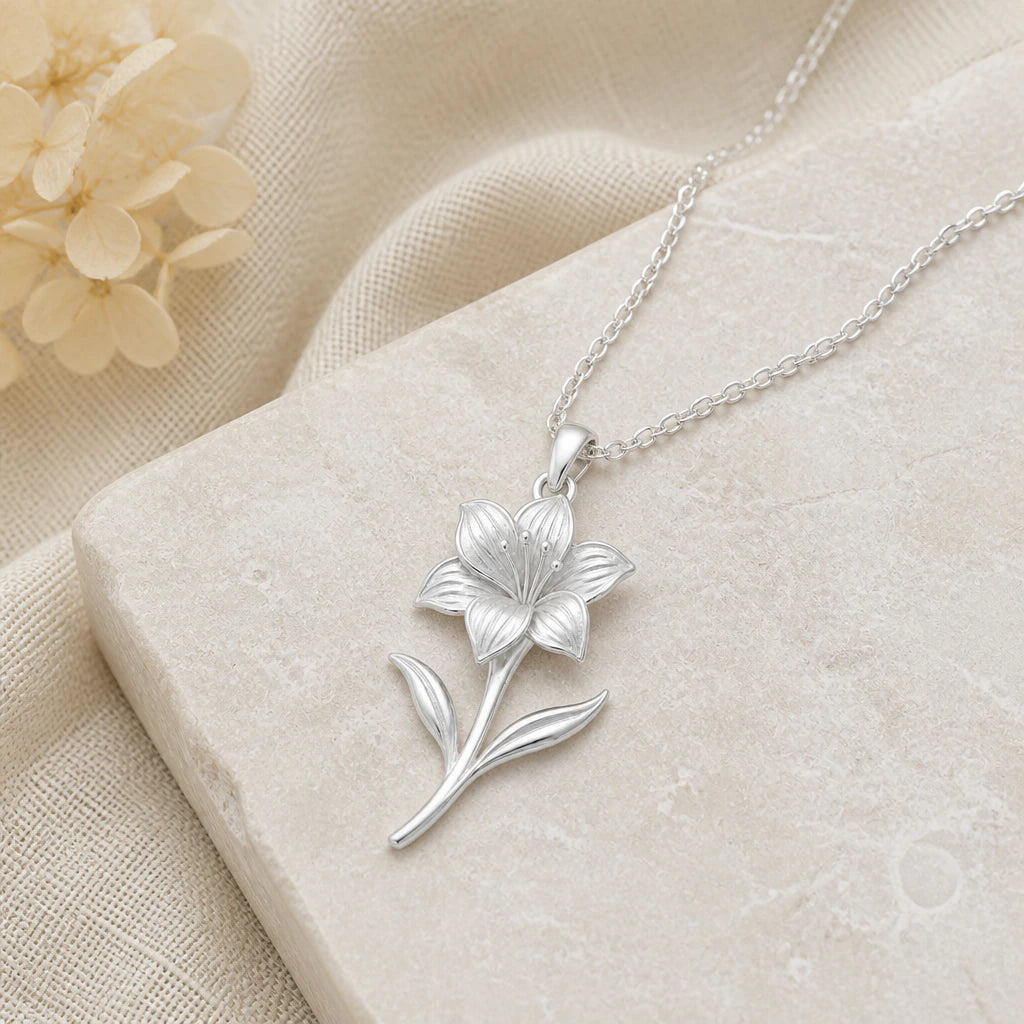Close-up of silver amaryllis flower pendant showing the sculpted detail