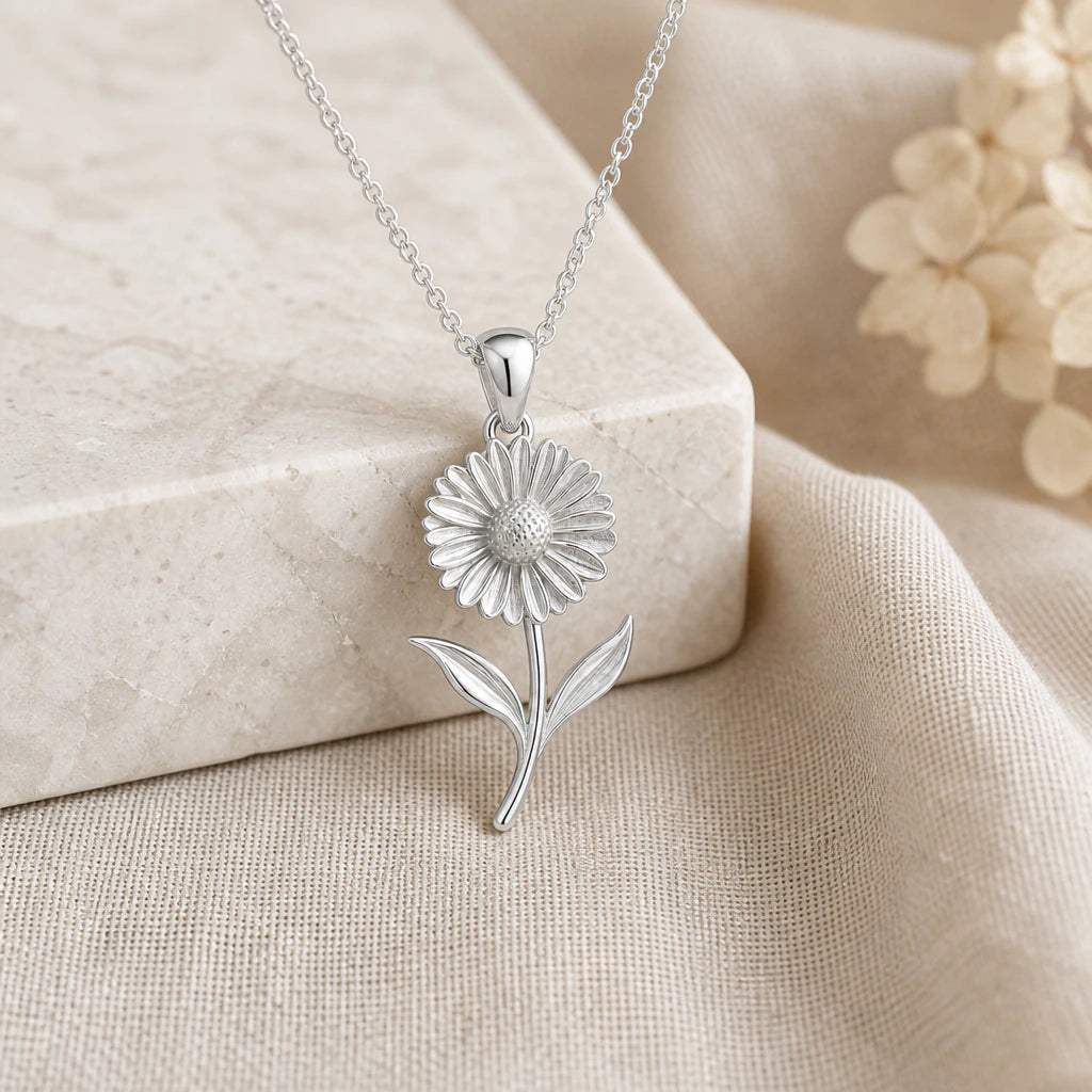 925 sterling silver calendula flower pendant necklace on softly folded cream linen