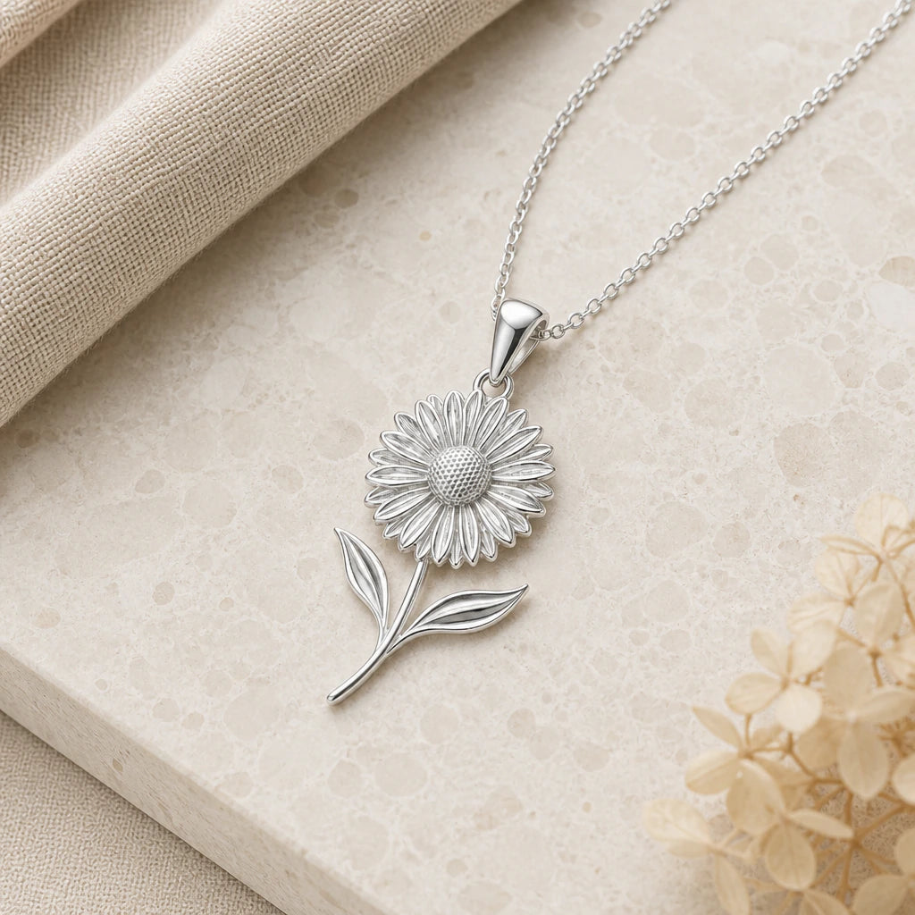 Close-up of silver gerbera daisy flower pendant showing the sculpted detail