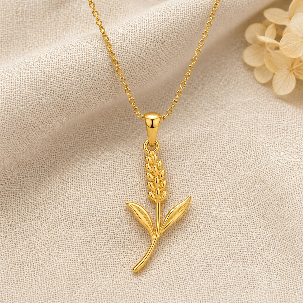 Lavender Flower pendant necklace in a warm gold finish on cream fabric